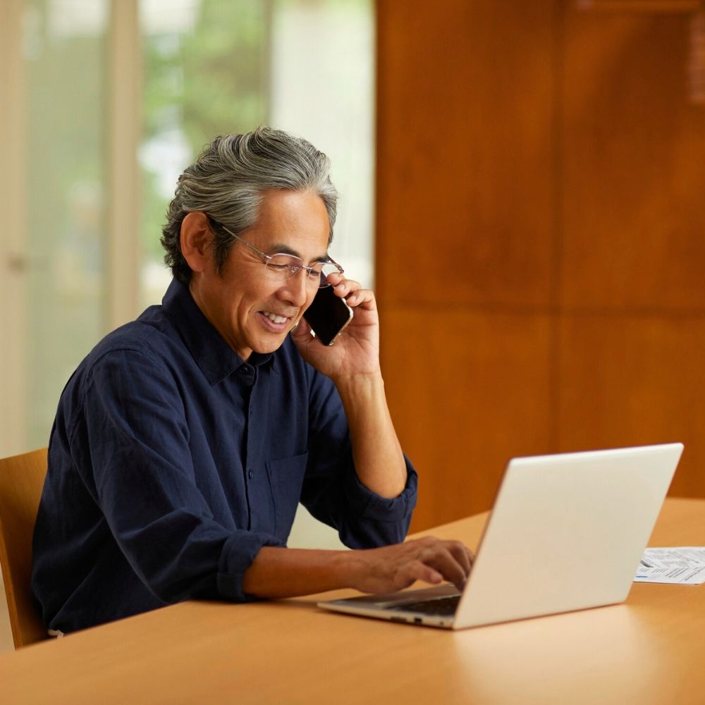 Business man on computer and phone