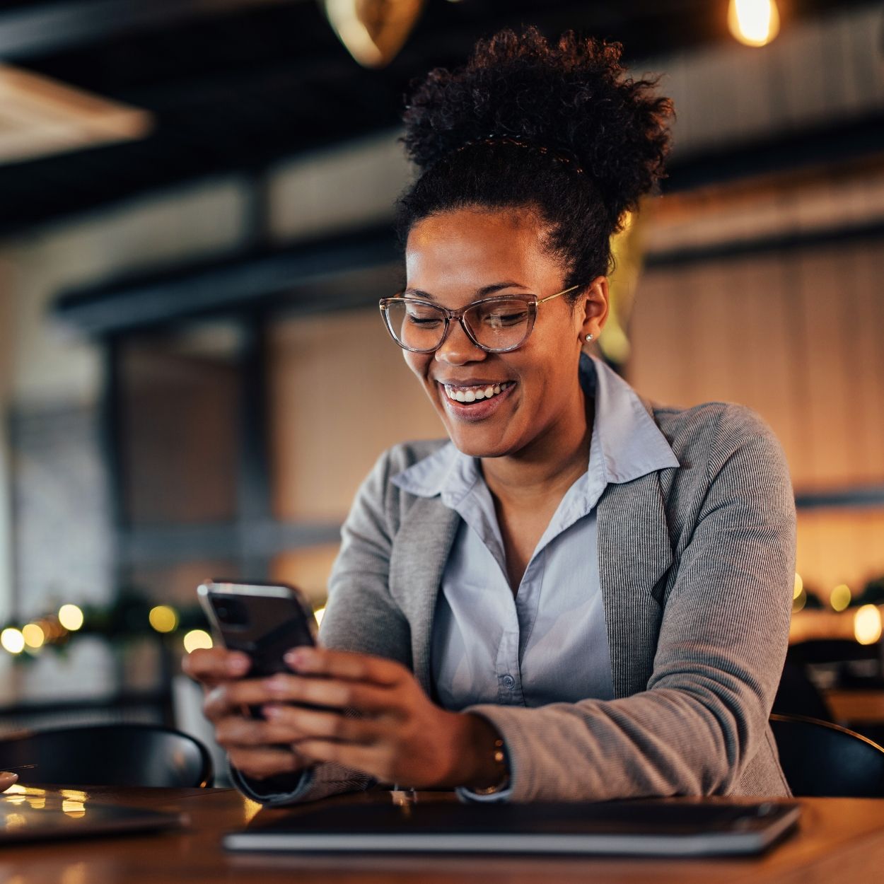 Business woman smiling at her phone